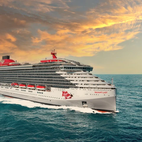 cruise ship in water during sunset