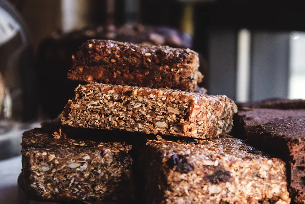 Pile of chocolate brownies on wooden plate