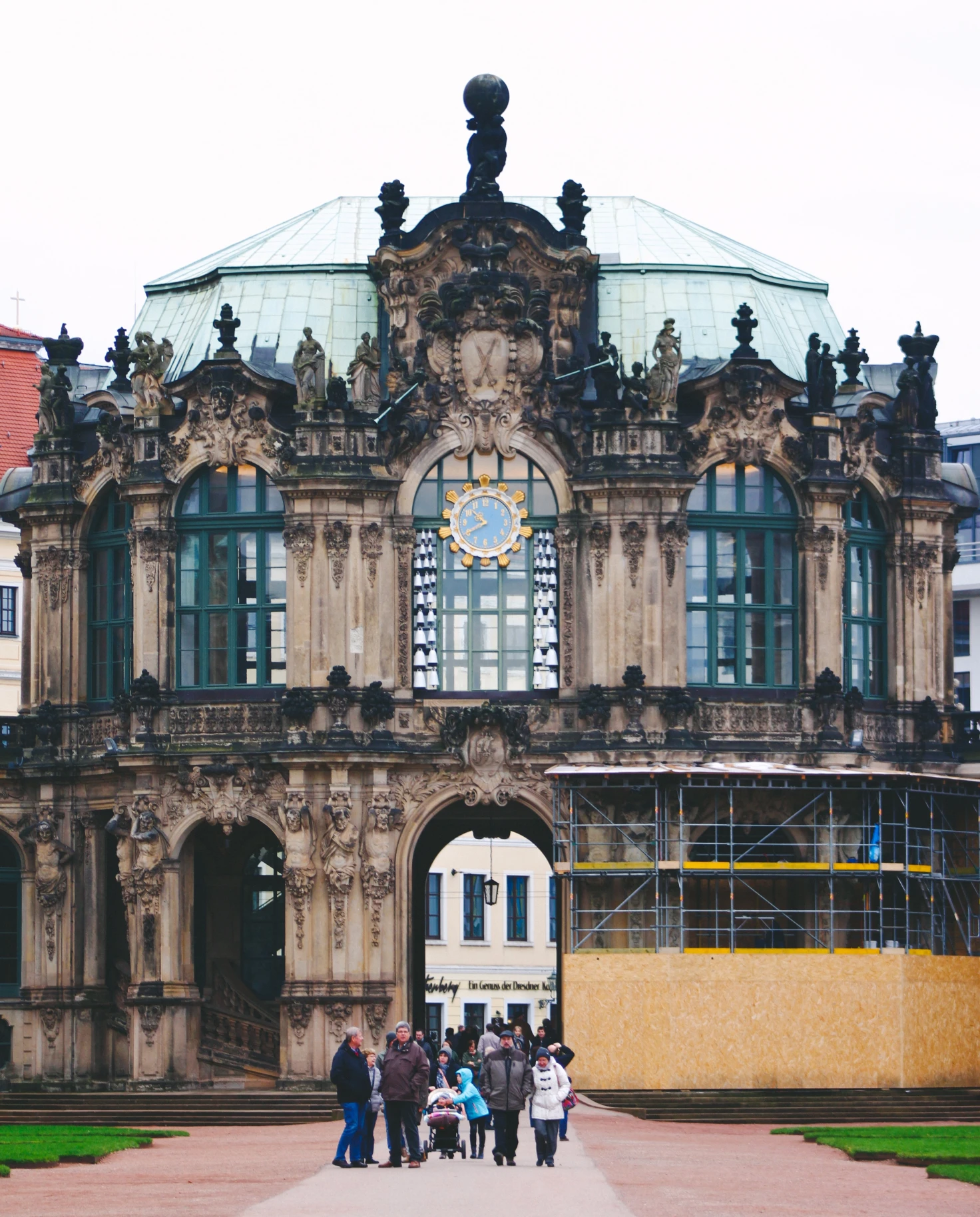 People walking in front of brown concrete building in Dresden.