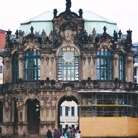 People walking in front of brown concrete building in Dresden.