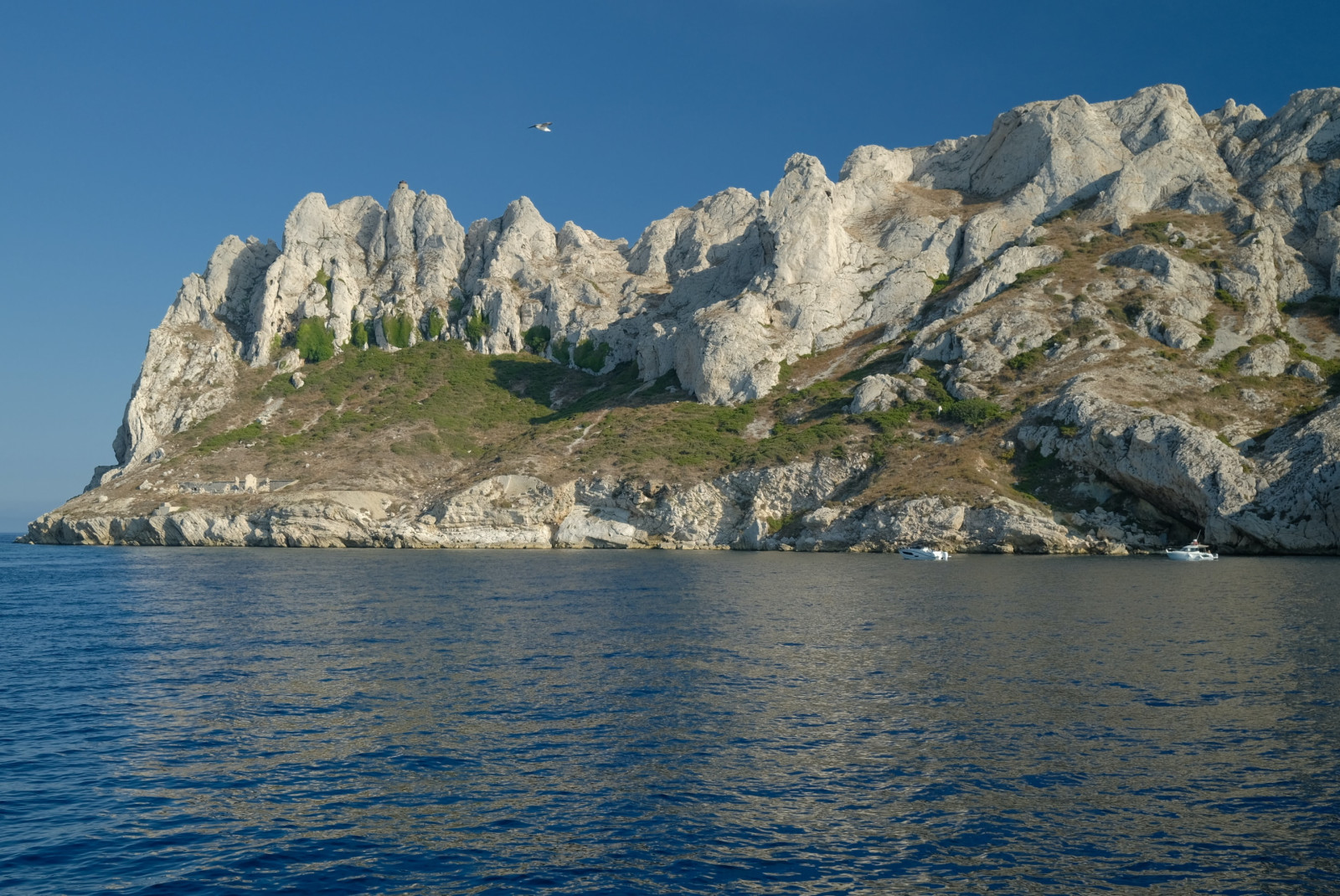 rocky coastline next to body of water during daytime