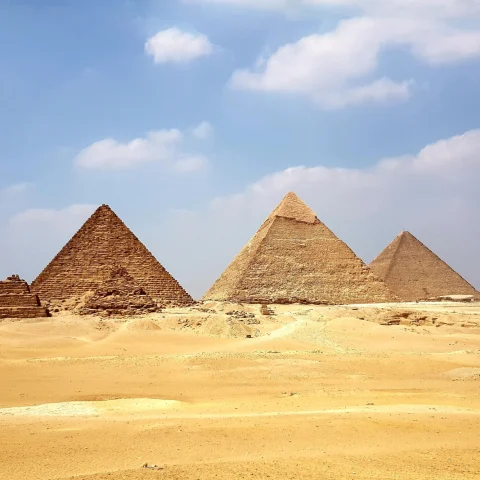 Egyptian pyramids on a yellow sandy desert on a sunny day