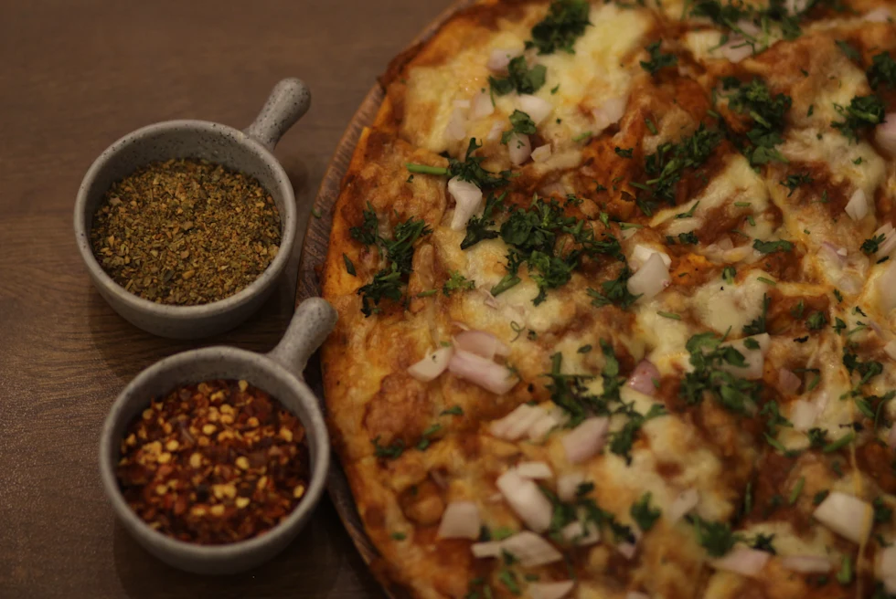 A close shot of Pizza and spice