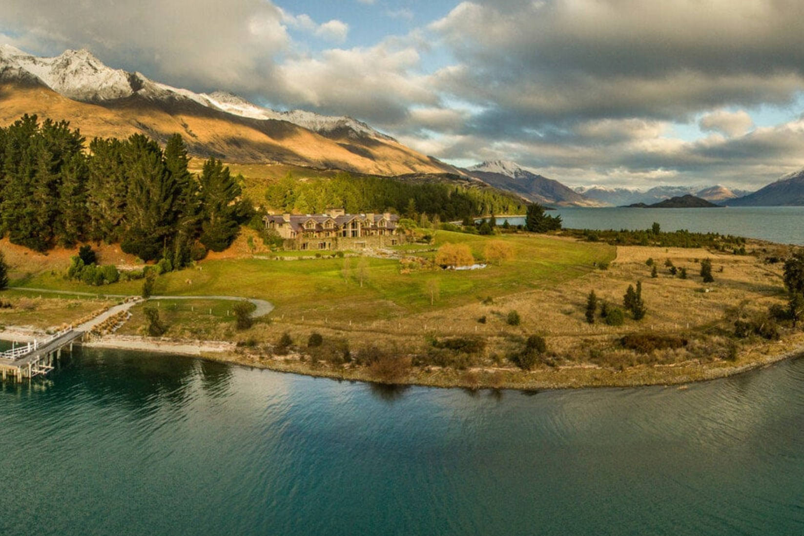 a rustic alpine lodge on a gassy expanse overlooking a lake