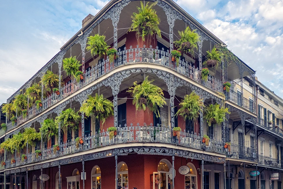 A huge building having trees hanging on the balcony