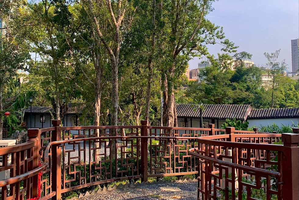 walkway with red fencing in a green park
