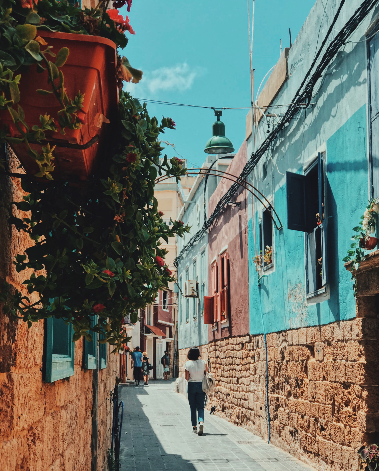 Girl walking down colorful street on a sunny day during daytime