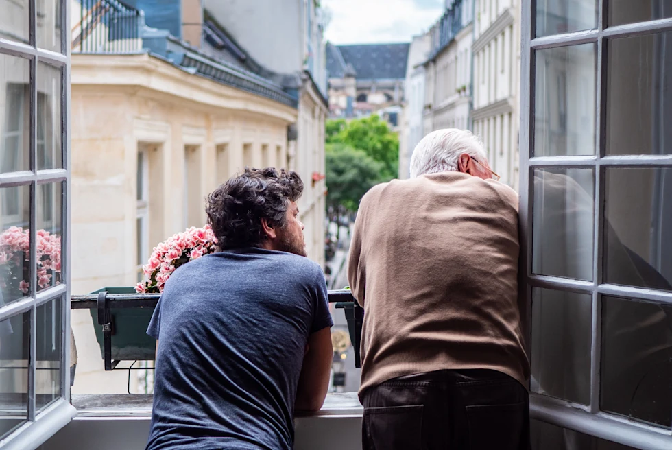 Two men looking out of the window in Le Marais.