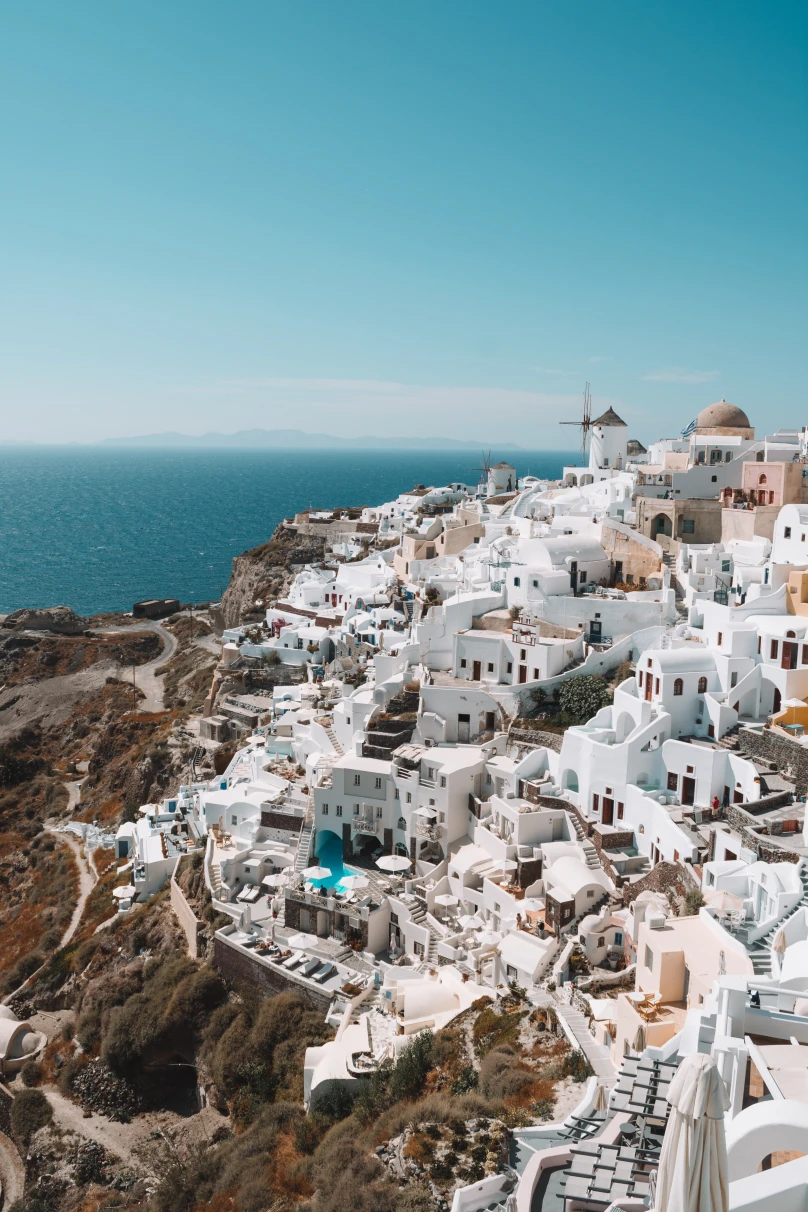 A cliffside view of white Greek homes. 