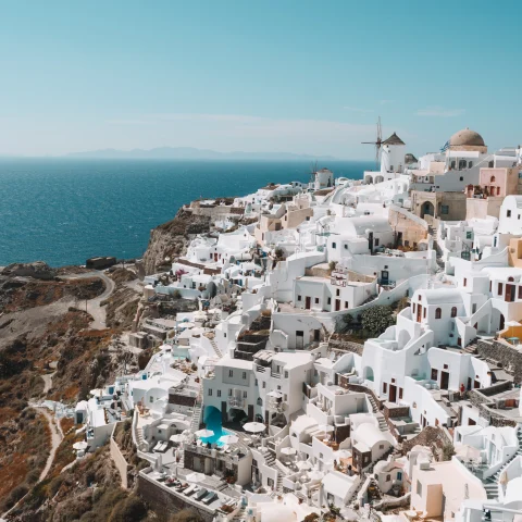 A cliffside view of white Greek homes. 