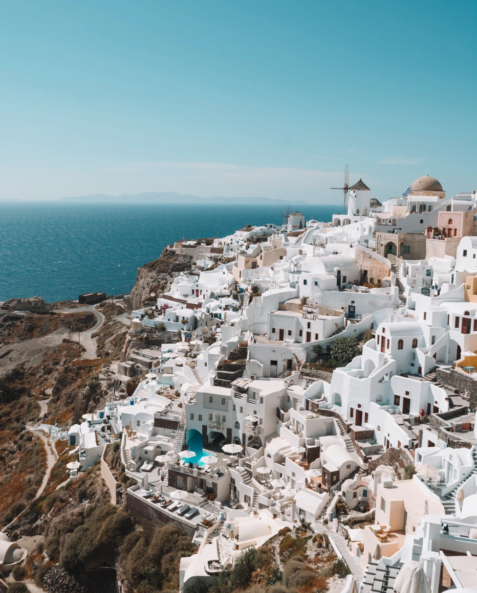 A cliffside view of white Greek homes. 