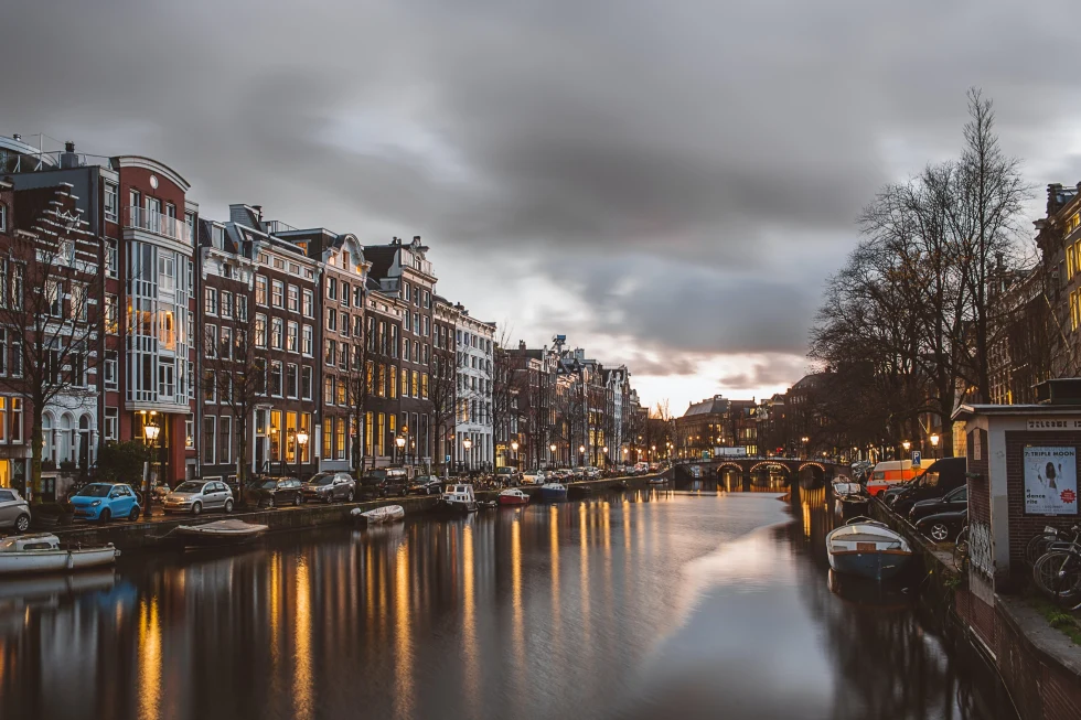 A picture of Amsterdam's canals posted with small houses. 