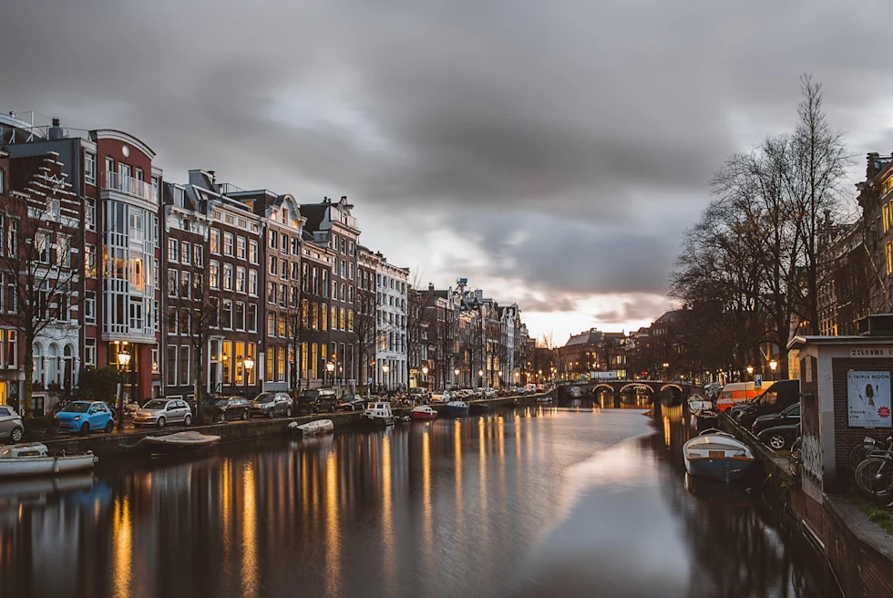 A picture of Amsterdam's canals posted with small houses.