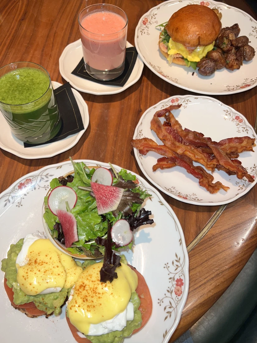 An aerial view of a cooked breakfast on a table with smoothies