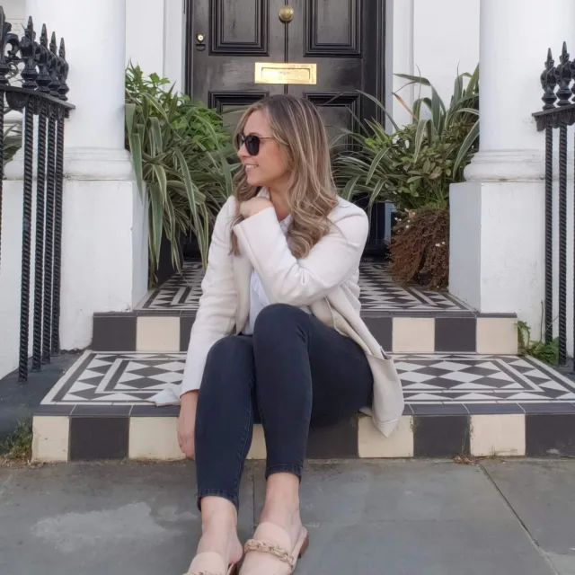 Travel Advisor Kelly Larkin in black and white sitting on a porch.