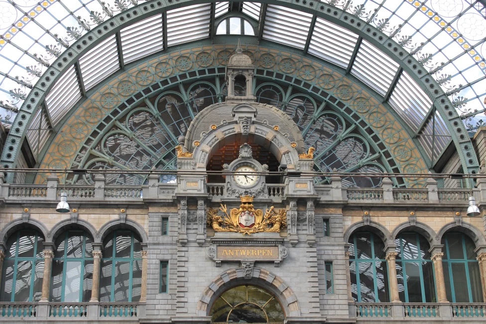 A historical building in Antwerp with clock on the entrance wall.
