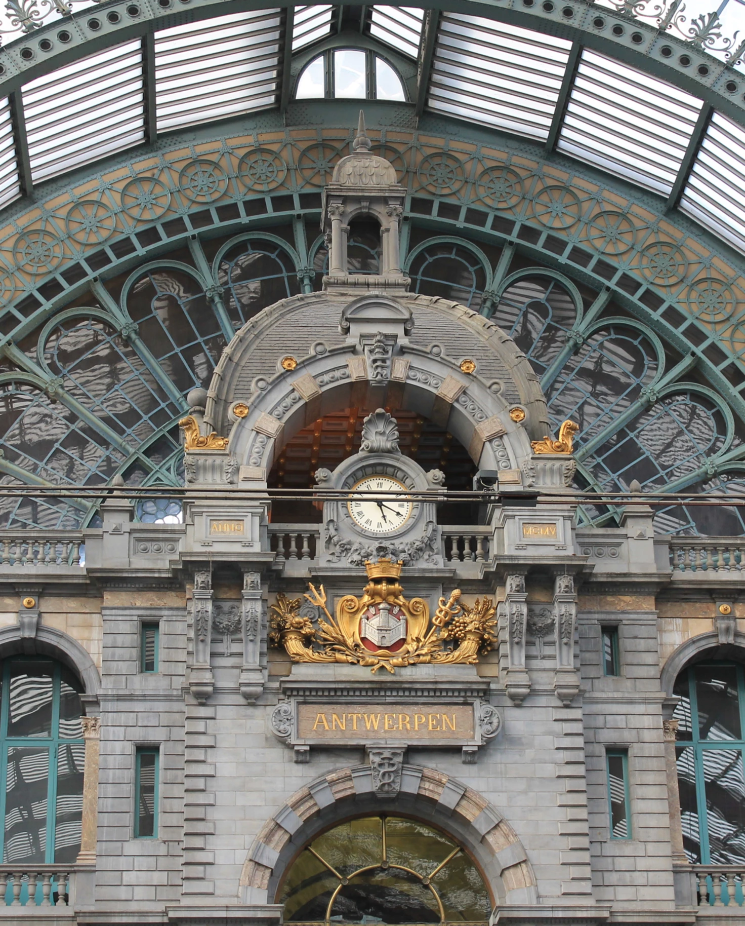 A historical building in Antwerp with clock on the entrance wall.
