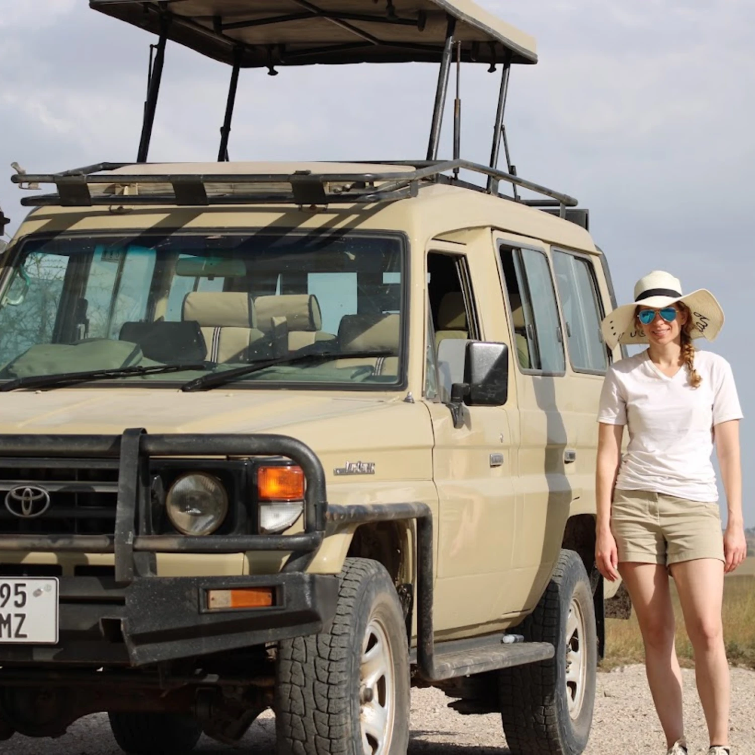 travel advisor stands with safari jeep