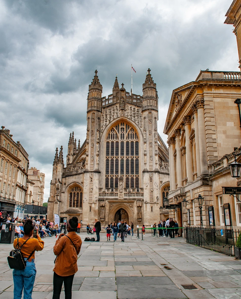 people standing in front of large building during daytime