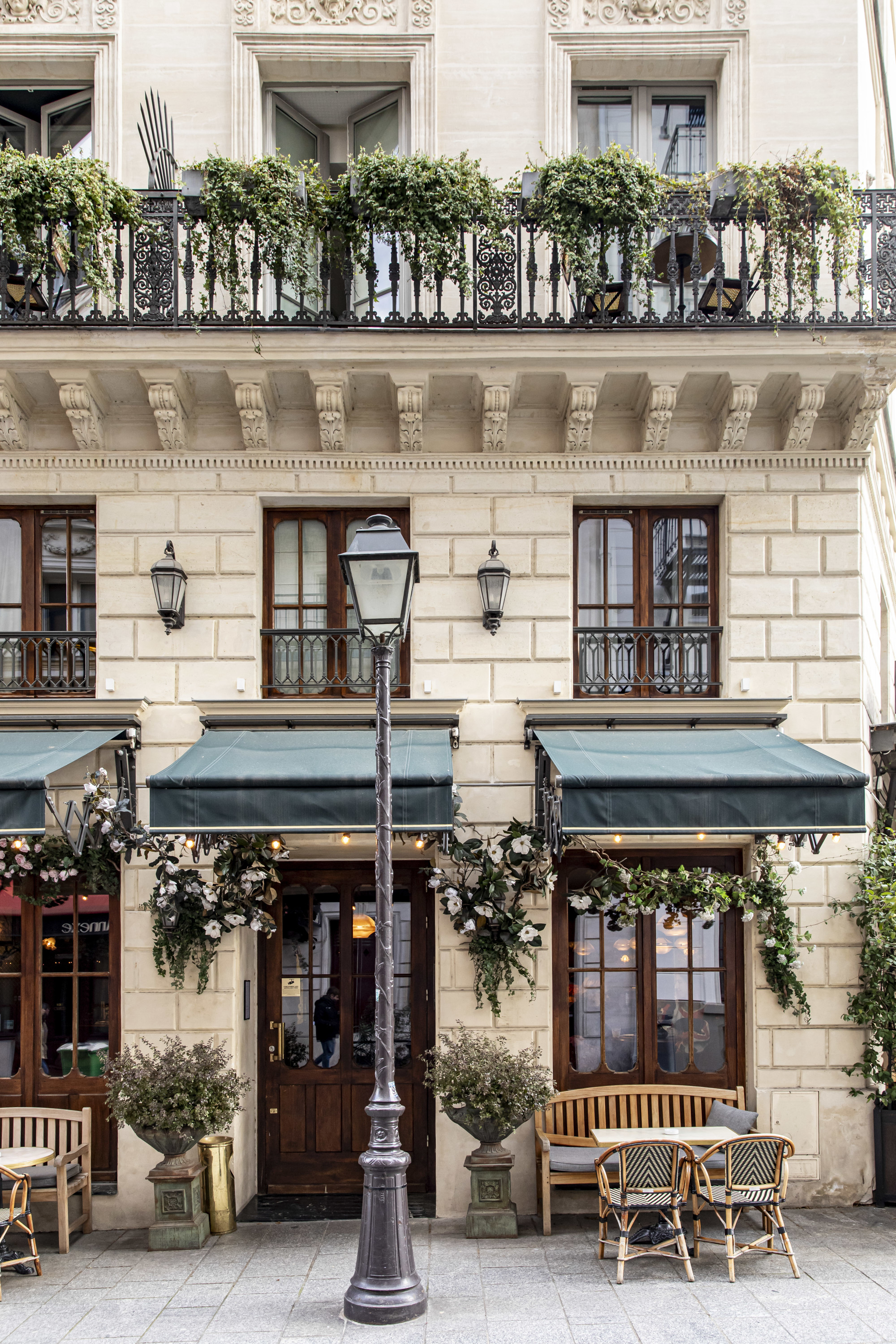 a lamp post outside of an elegant building in Paris