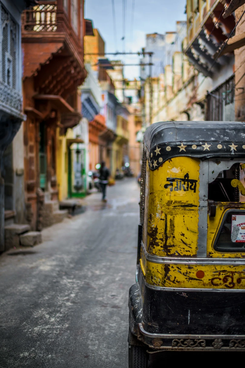 Yellow rickshaw on the road of Jodhpur, India.