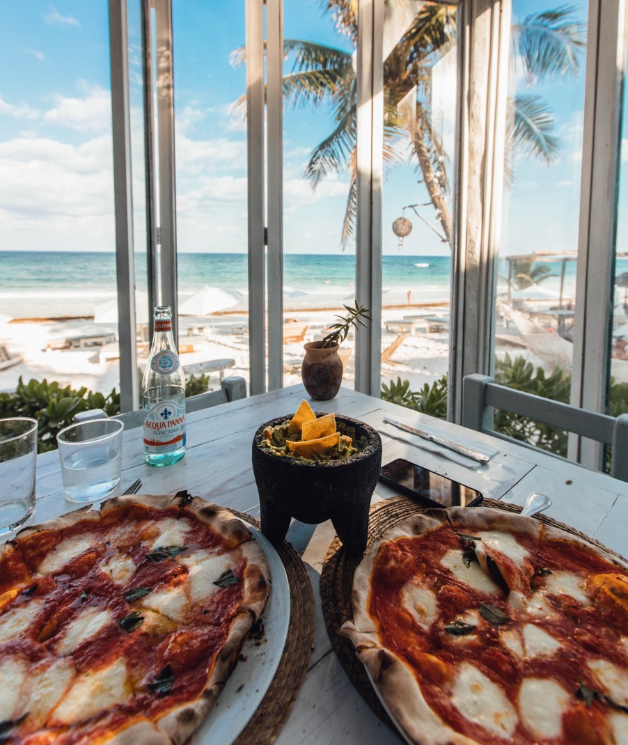 pizza on table with views of the ocean