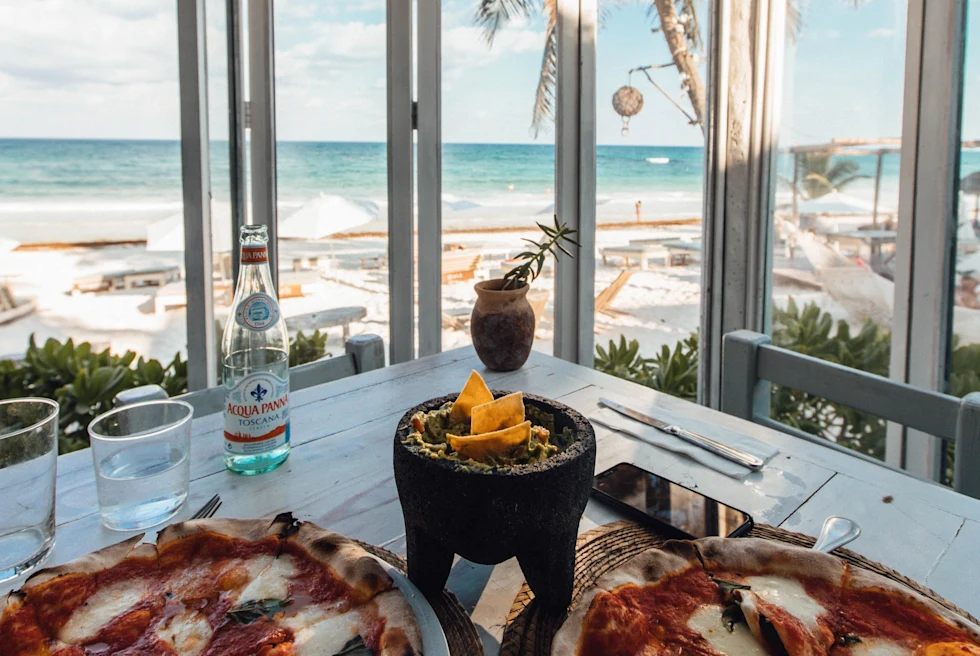 pizza on table with views of the ocean