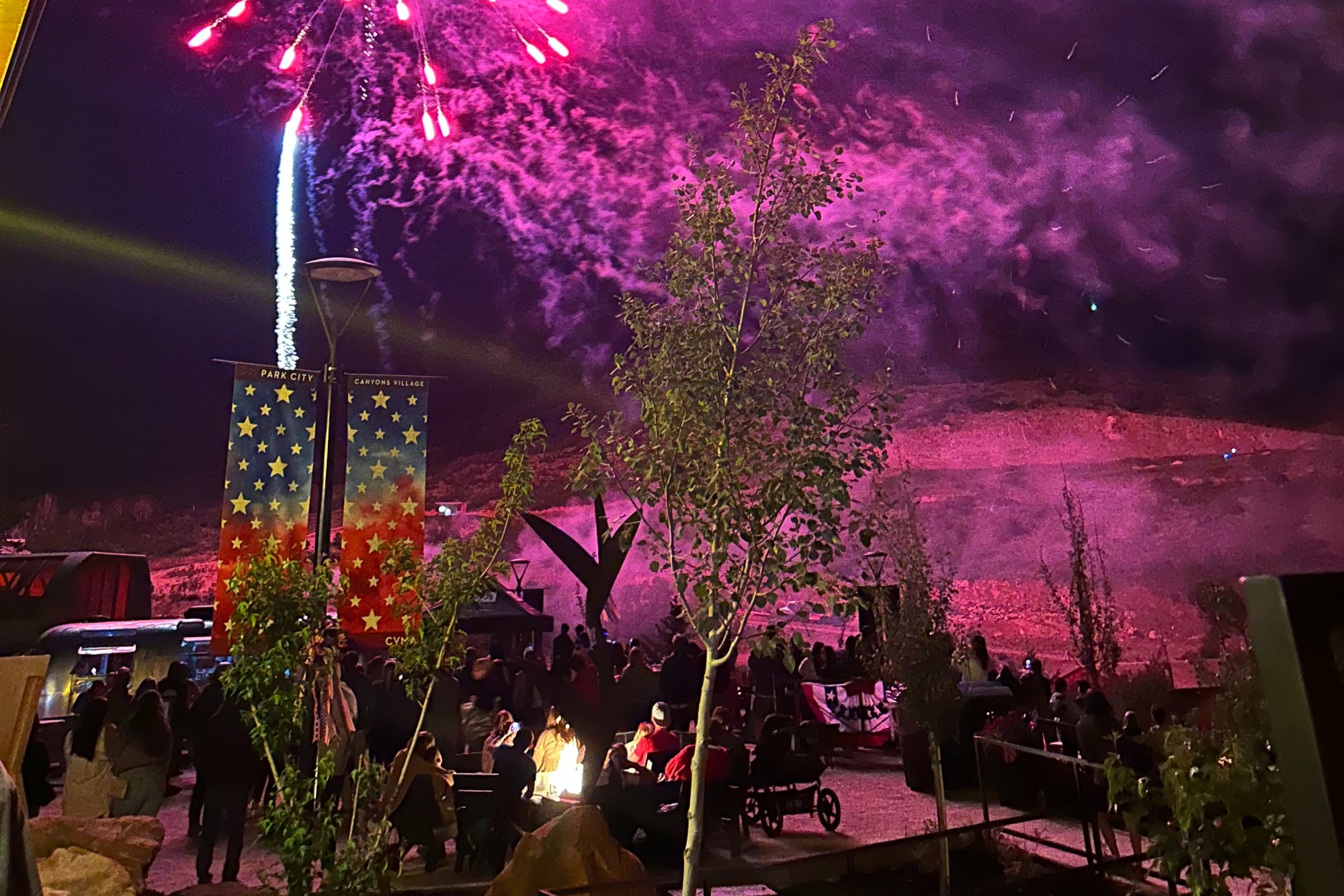 An outdoor sitting with fireworks at night. 