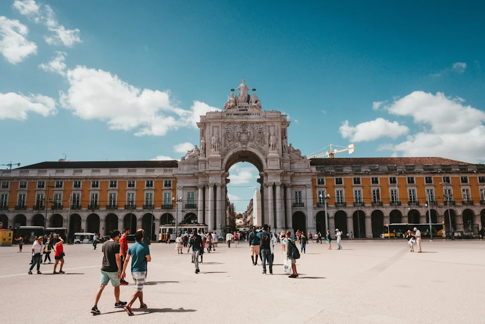 The center of Lisbon featuring a monument with tourists in the square. 