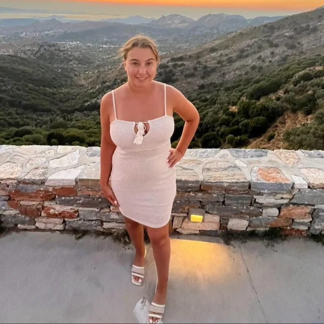 Picture of Gabriella in white dress with the mountains in the background.