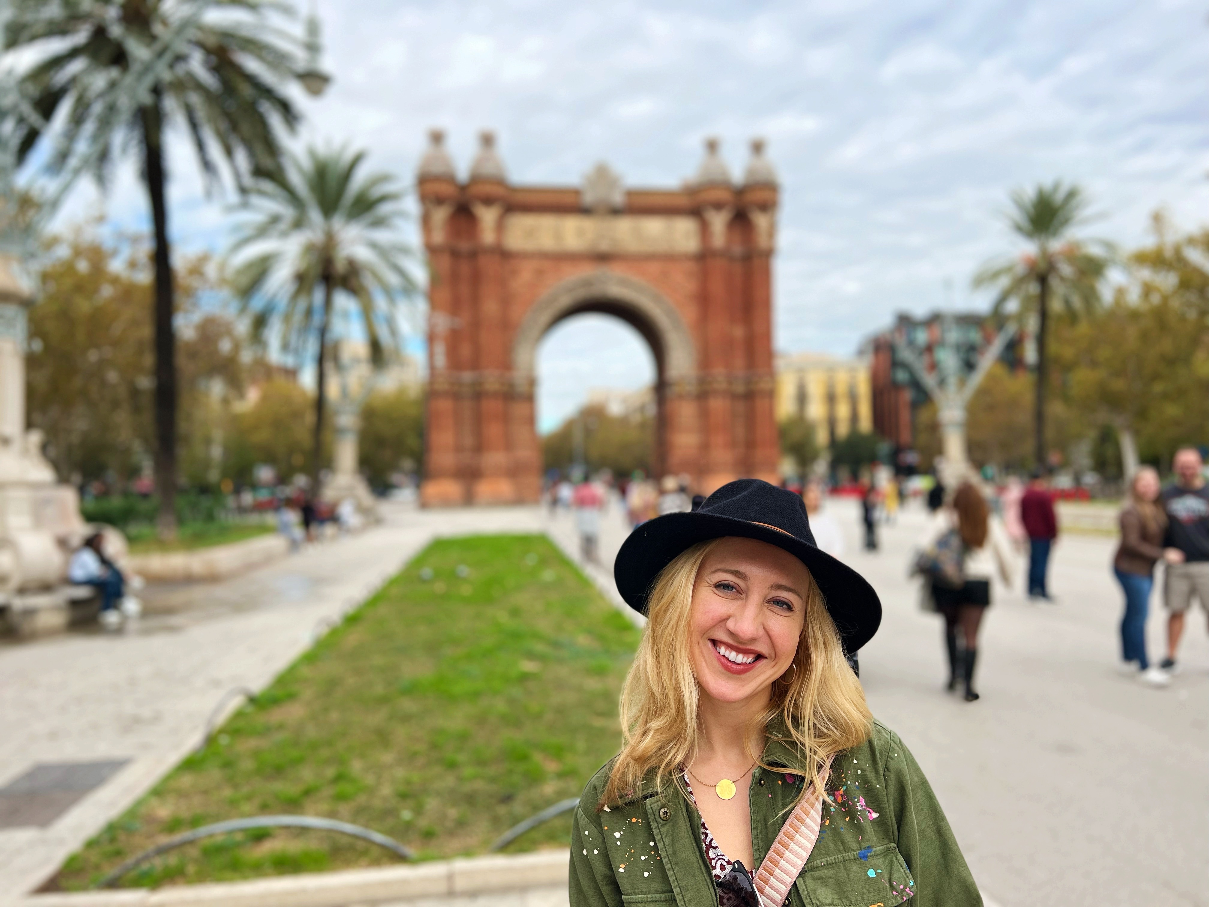 A woman posing in front of a beautiful gate