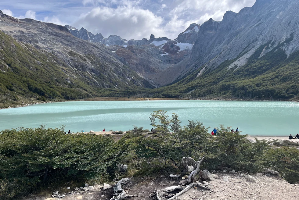 Lake surrounded by snow clad mountains.
