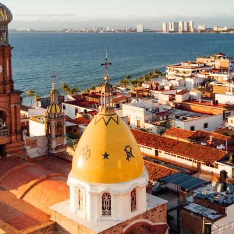 An aerial view of the city with the ocean in the distance.