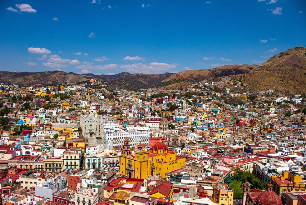Aerial view of city with colorful buildings. 