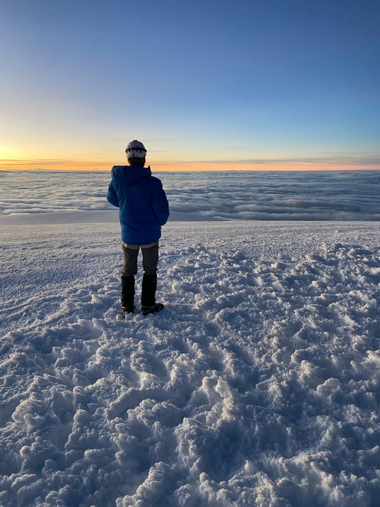 Stephen standing on snow with a sunset in the background