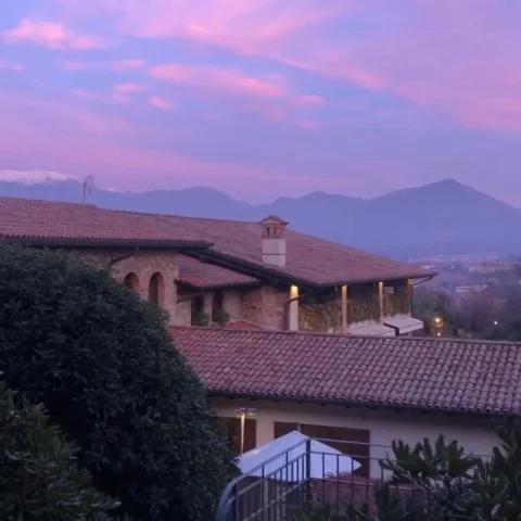 A view from the top of the mountains in Lombardy, overlooking a lake. 