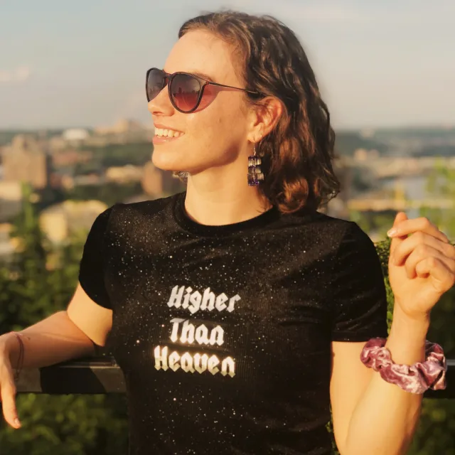 Travel advisor Liv Nagler smiles in sunglasses and a black tee-shirt