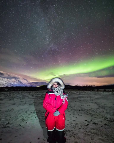 Advisor posing in front of the Northern Lights