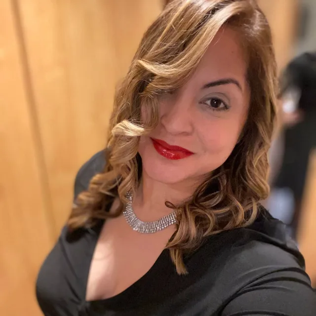 Travel Advisor Carmen Ortiz taking a selfie in black dress.