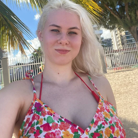 Travel advisor Arina Polyaeva taking selfie in a colorful dress.