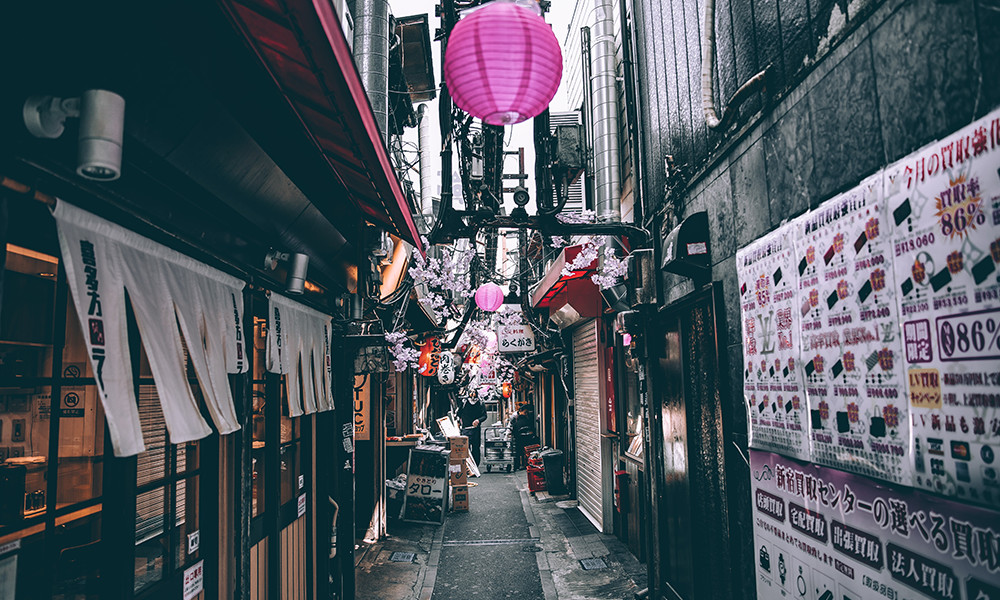 pink lantern in Japanese street with white flyers and grey concrete streets