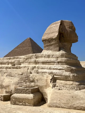 A view of the Great Sphinx of Giza in Egypt with the blue sky in the background. 