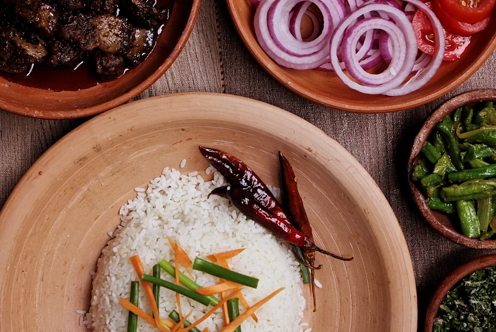 Plate of rice and vegetables on a wooden table