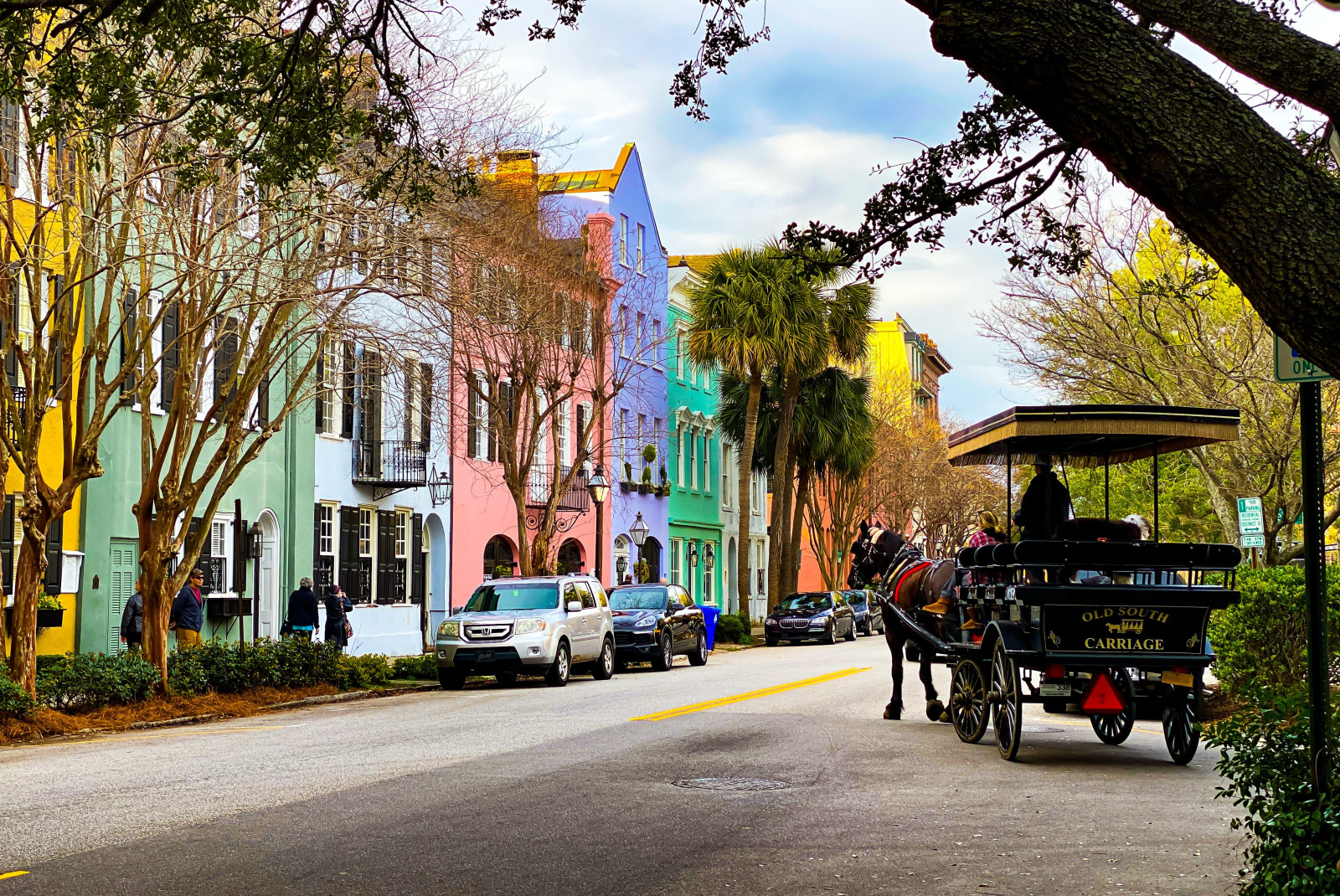 Colorful houses next to street with cars during daytime