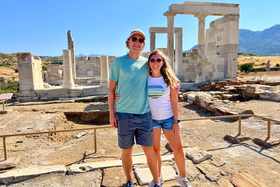 A couple standing in front of ruins in Naxos. 