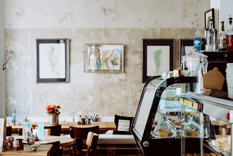 Counter and wood tables with white lamp at coffee shop