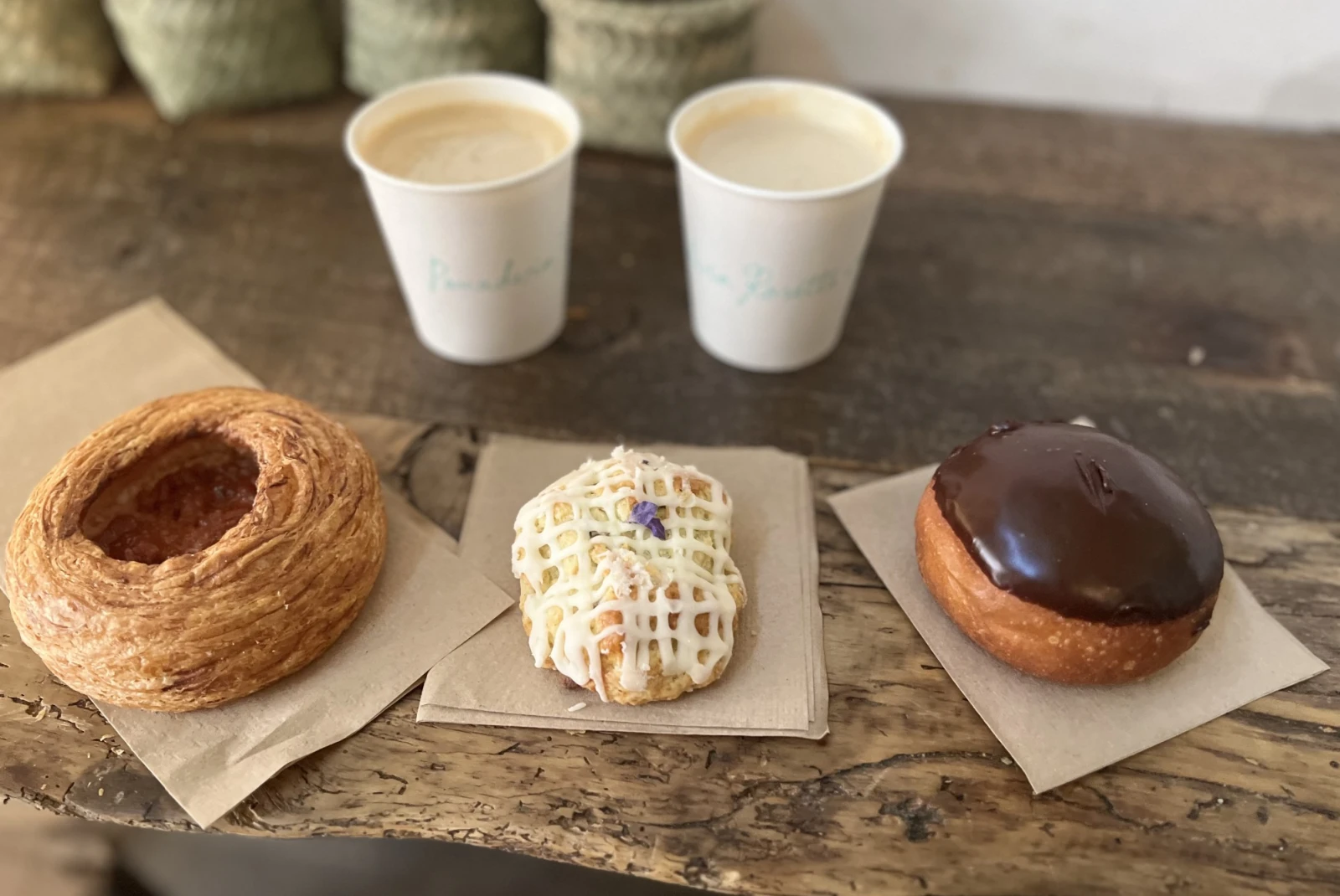 Three donuts with two coffees.