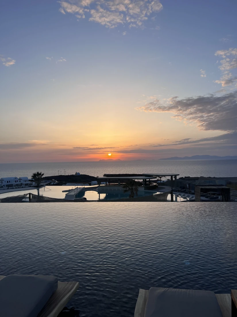 infinity pool overlooking the sea at sunset
