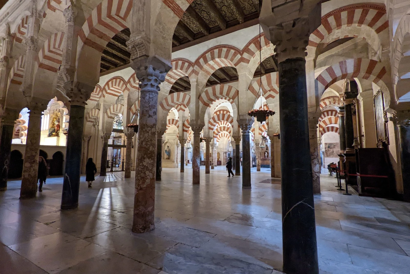 inside an old cathedral with white and red tile