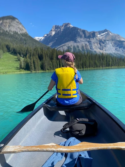 A girl kayaking on a lake. 
